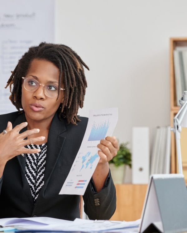 portrait attractive cuban woman presenting statistical information her unrecognizable boss (1)